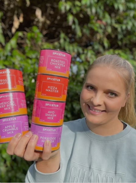 Artisan food producer holding Spice Tub seasoning blends featured in The Broth Sisters store.